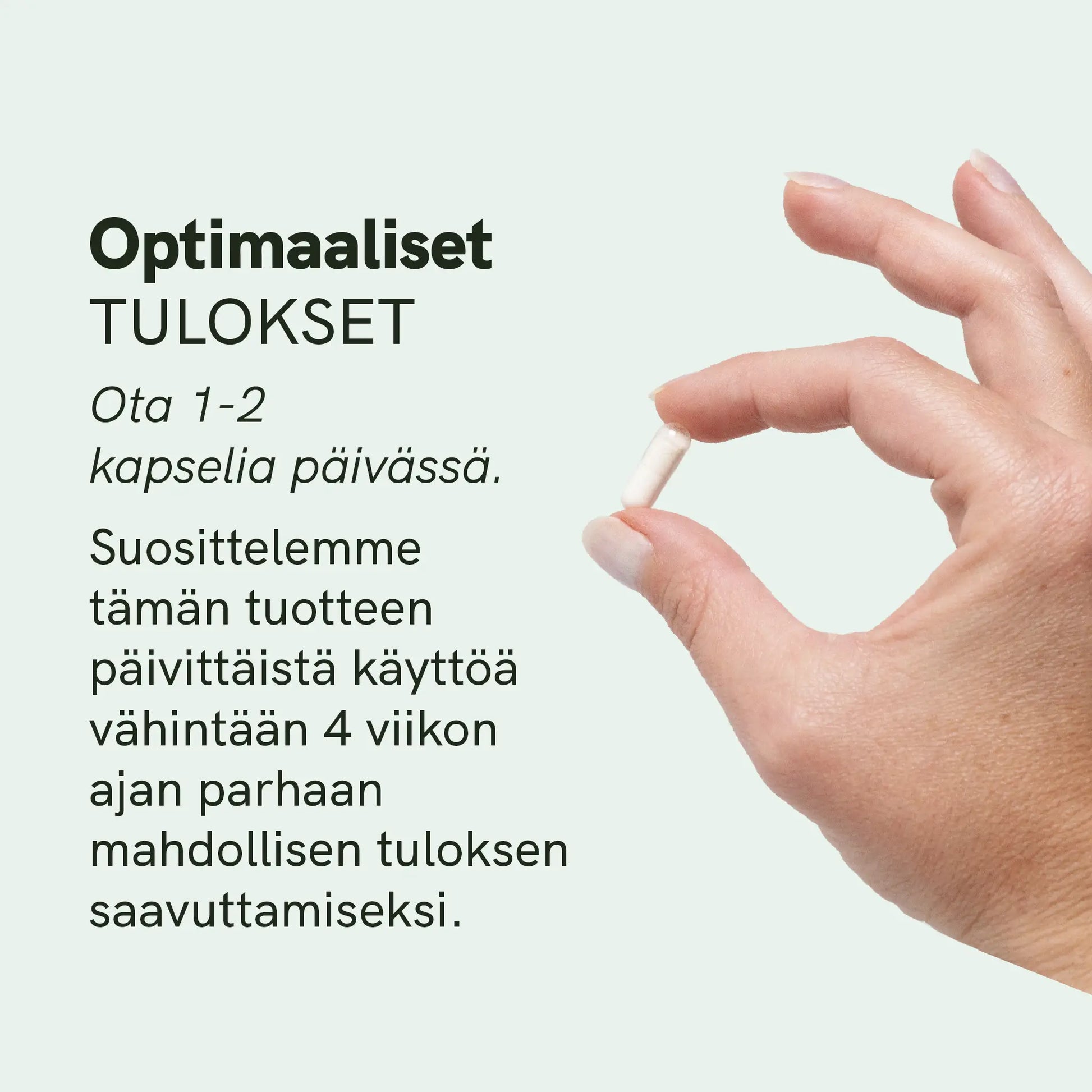 Käsi, joka pitää valkoista kapselia sormien välissä vaalean mintunvärisellä taustalla.
